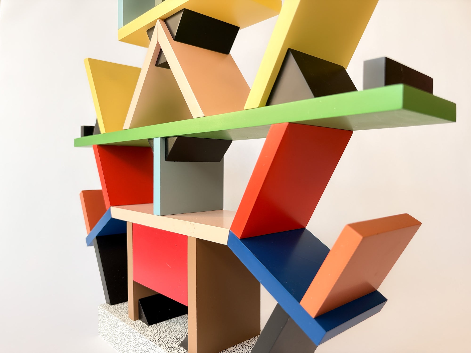 Colorful geometric shelf with various shapes on a neutral background