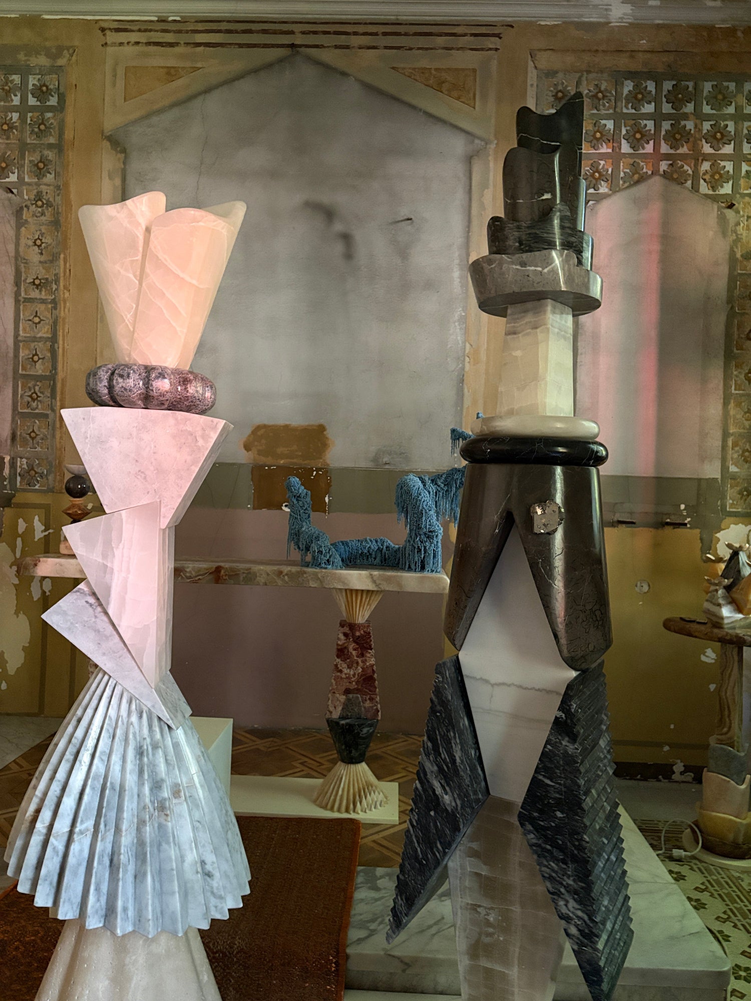 An abandoned former hospital room turned into a design showroom with contemporary marble sculptures.